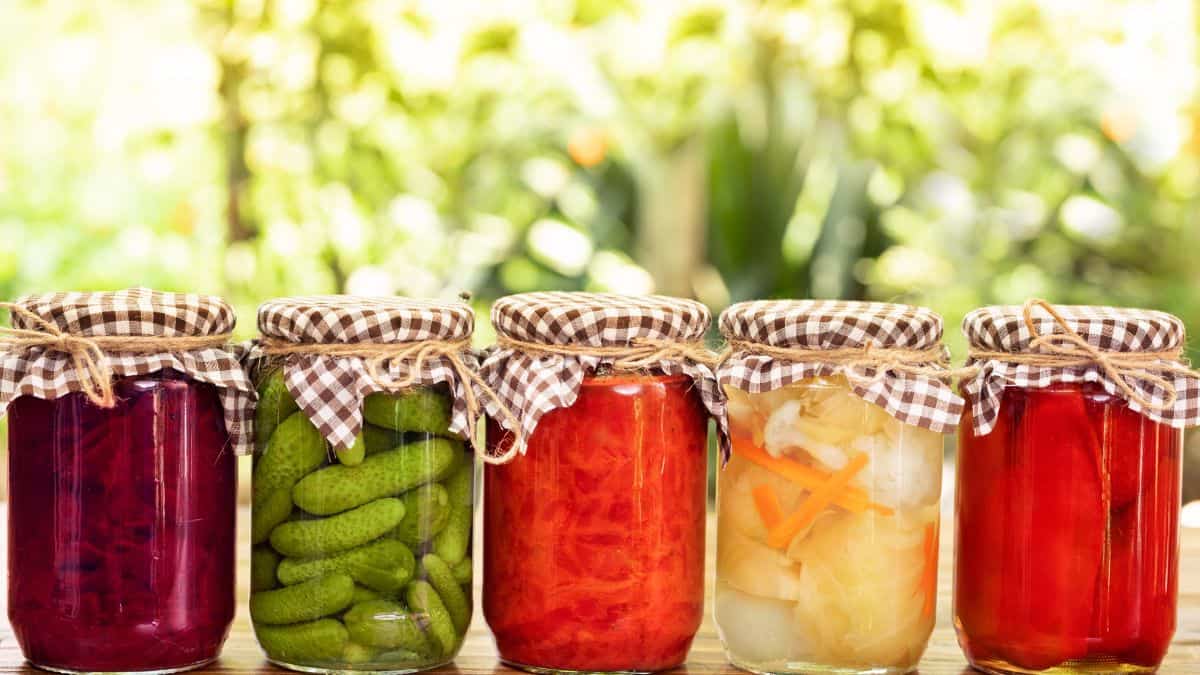 Pickled vegetable jars on a table.