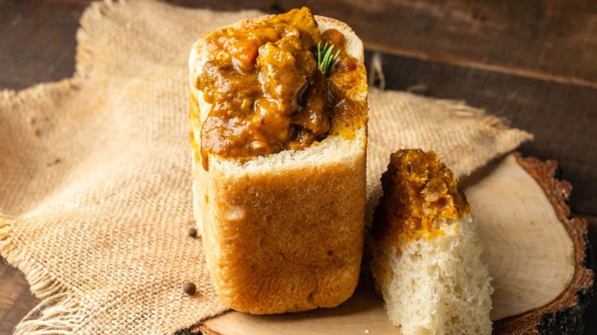 Bunny chow placed on a wooden surface.