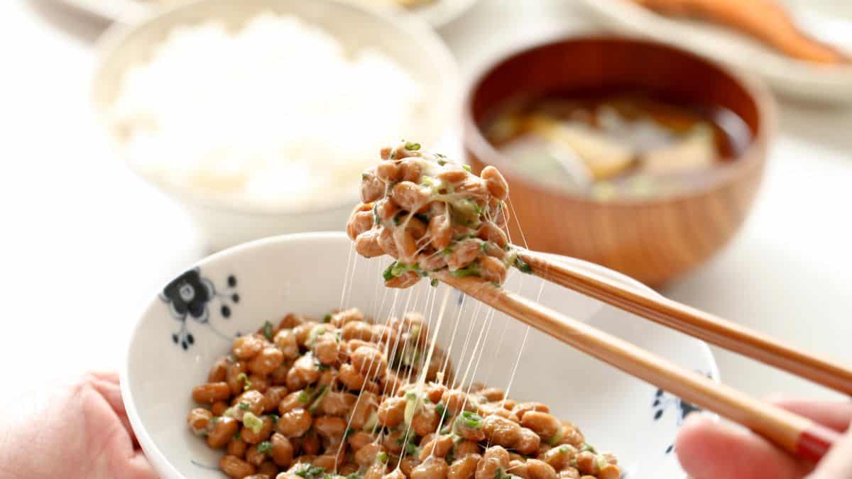 Person picking natto using chopsticks.