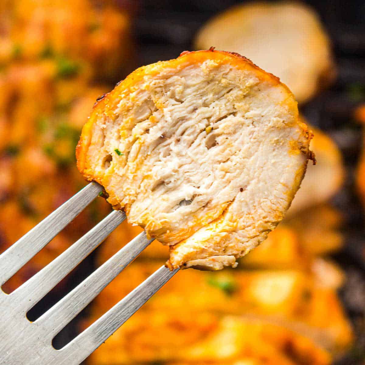 A slice of chicken breast on the fork.