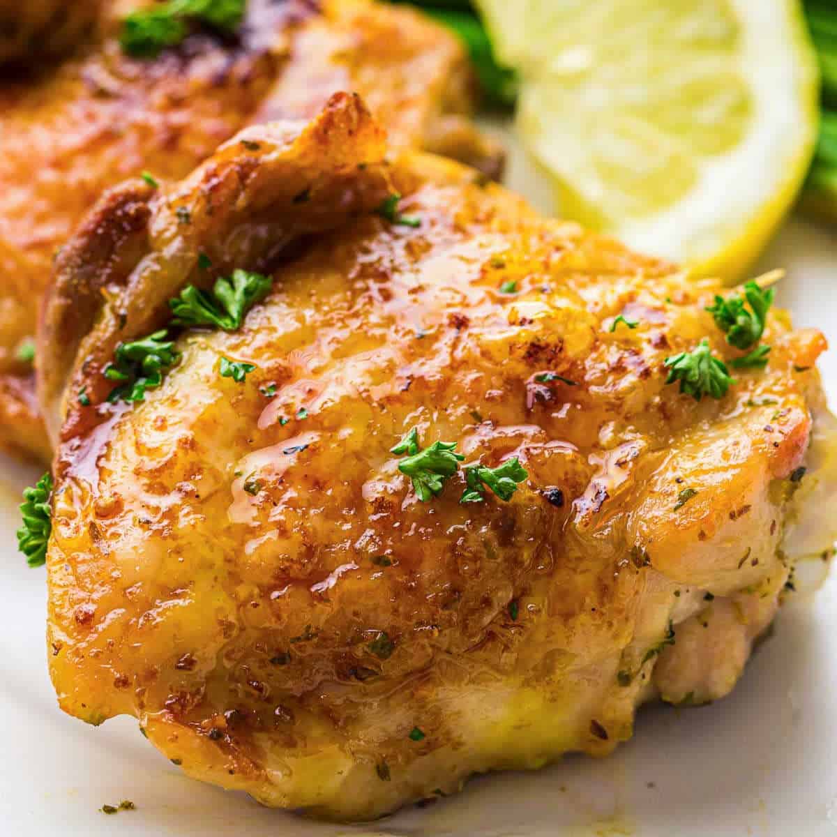 Air fryer chicken thighs garnished with parsley.