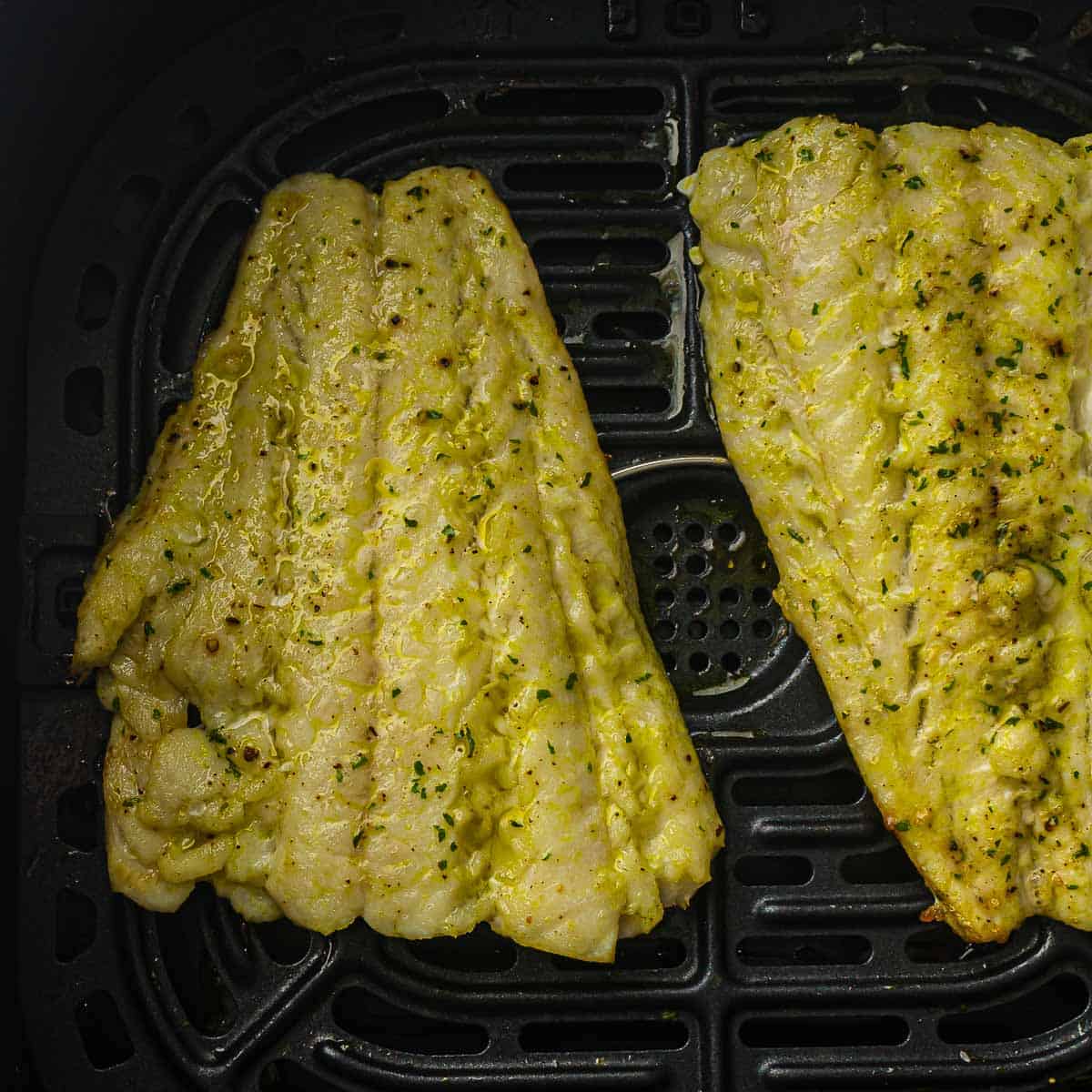 Air fried cod fillets in the basket.