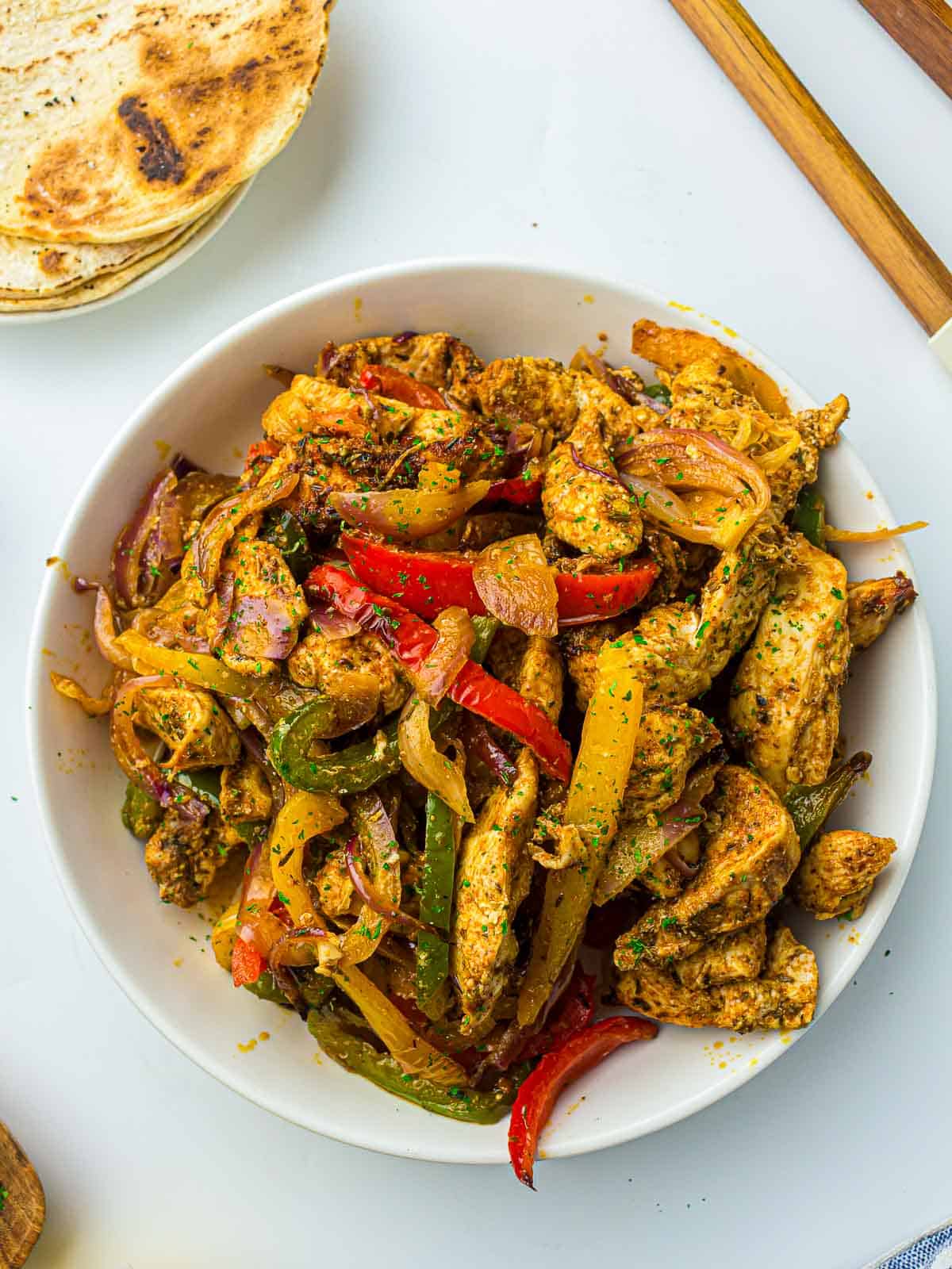 Air fryer fajitas on a white plate.