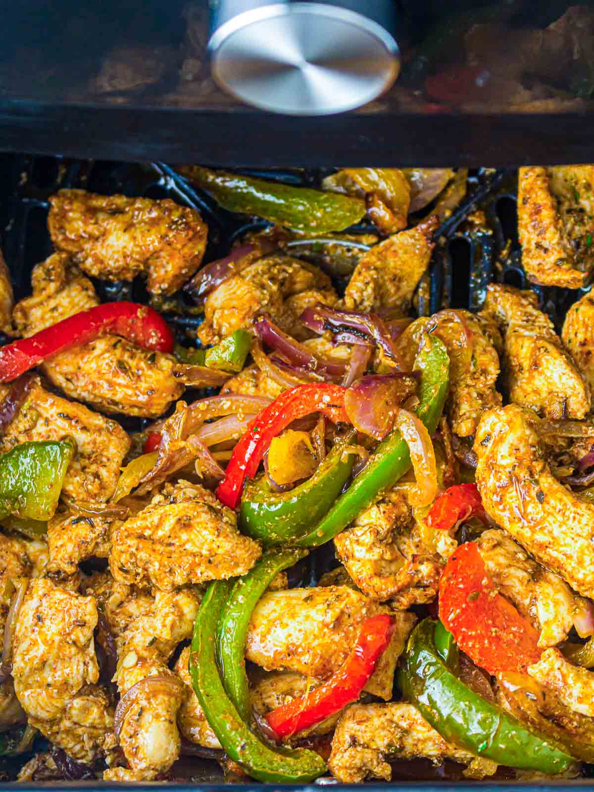 Cooked chicken and veggies in the air fryer.