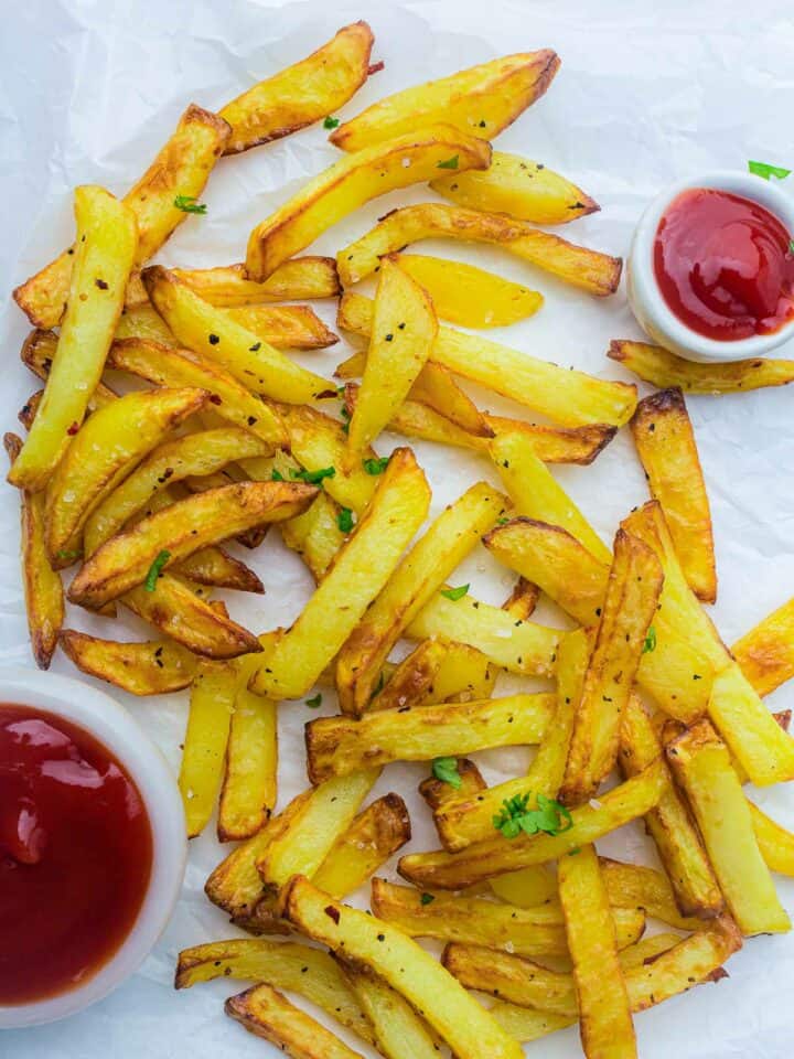 Homemade fries served with ketchup and hot sauce.