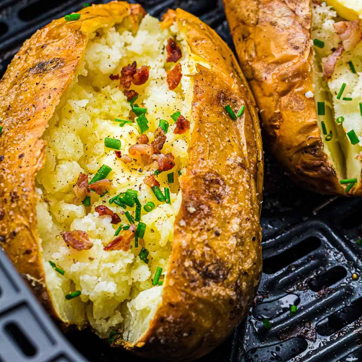 Baked jacket potatoes topped with bacon bits and chives.