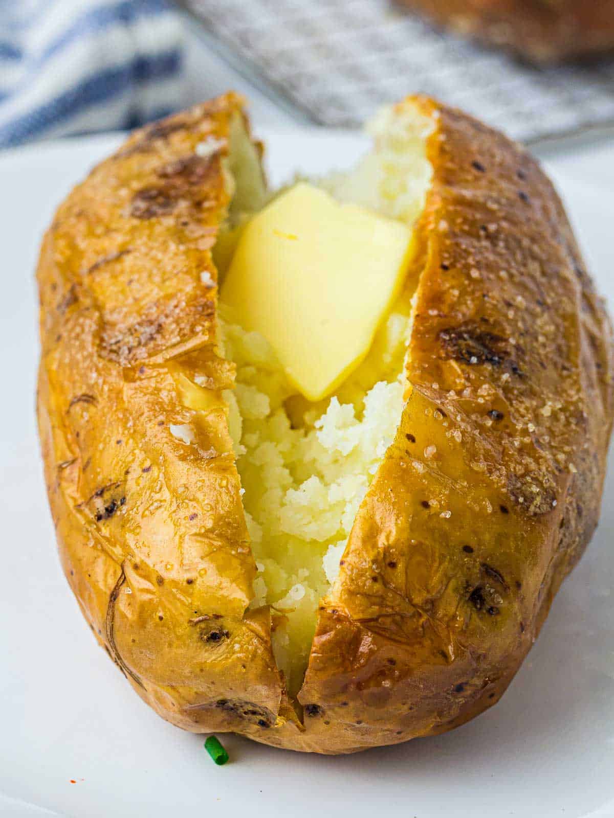 Jacket potato cut and topped with butter.