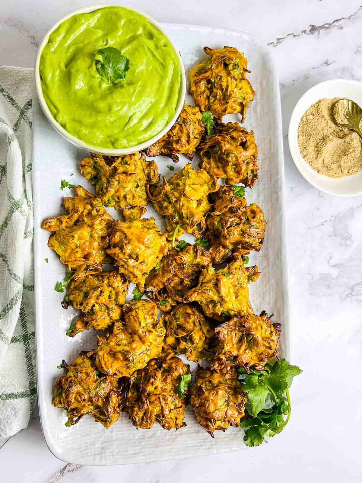 Brussels sprouts pakora on a white plate.