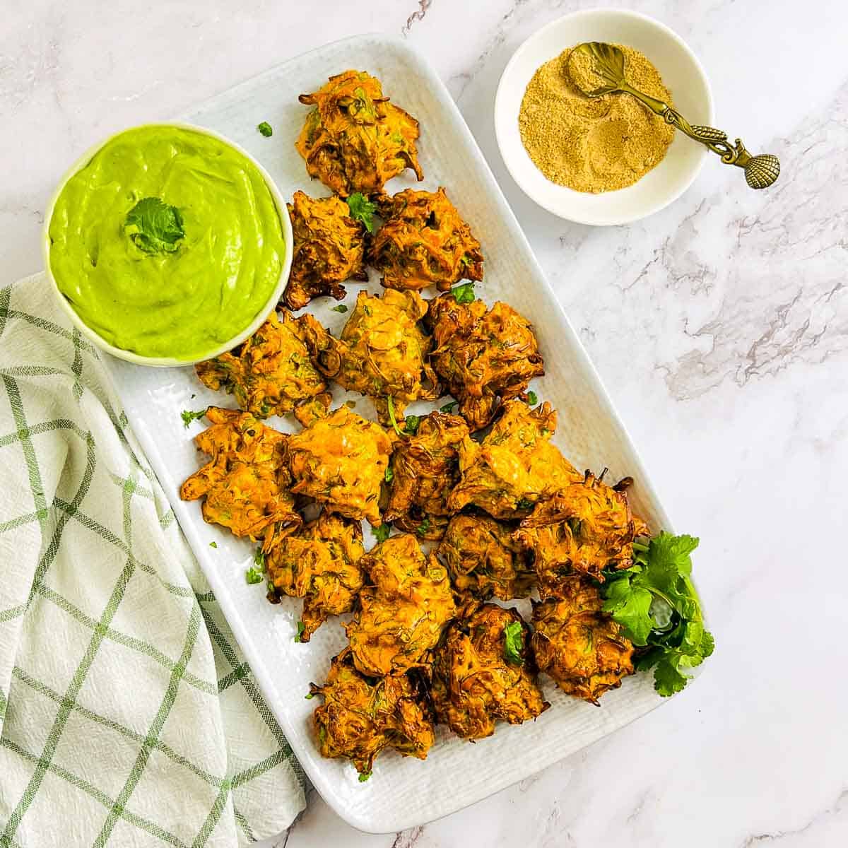 Brussels sprouts pakora garnished with chaat masala and cilantro.