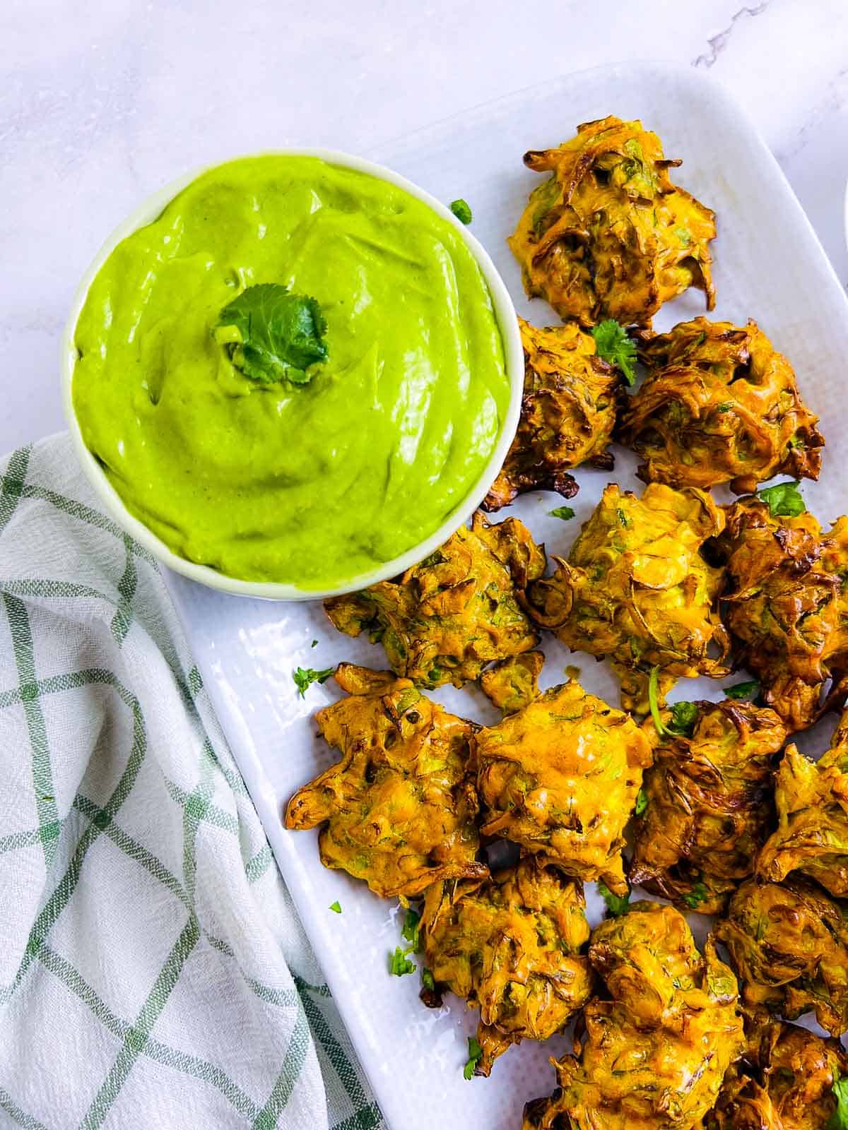 Brussels sprouts pakora and green chutney close up.