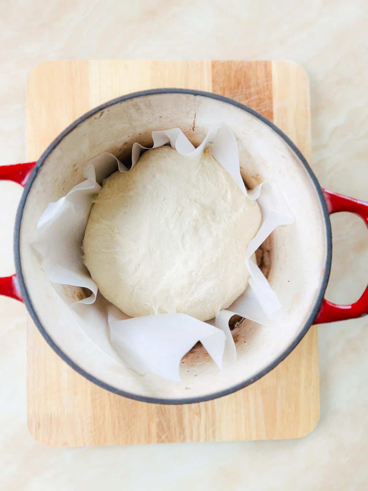 Shaped dough in hot Dutch oven.