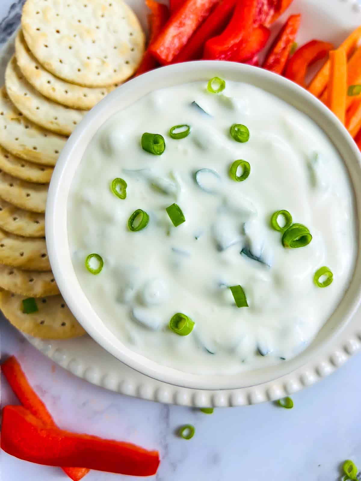 Green onion dip bowl garnished with green onions.