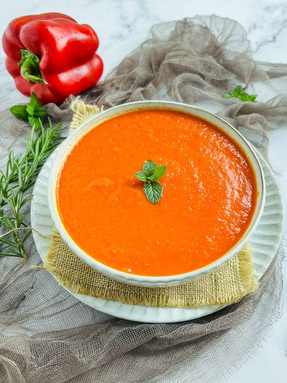 Roasted bell pepper and habanero sauce in a white bowl.