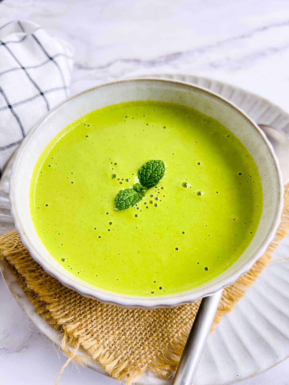 Mint peanut chutney garnished with mint leaves.