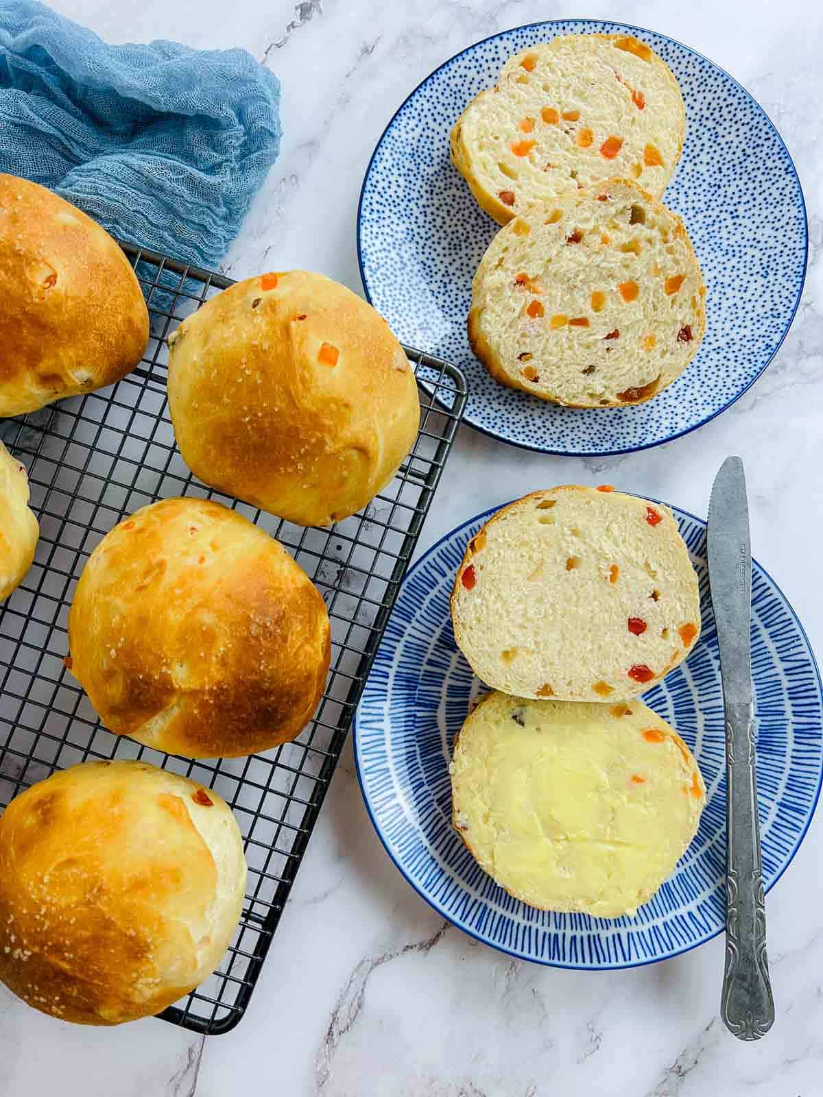 Two sliced buns on blue plates.