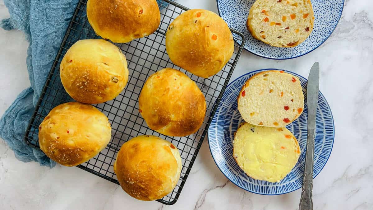 Bun maska on a plate topped with butter.