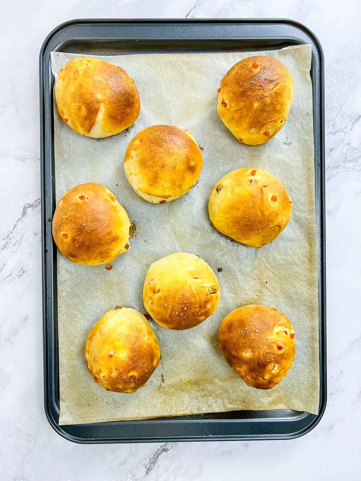 Baked buns on a baking sheet.