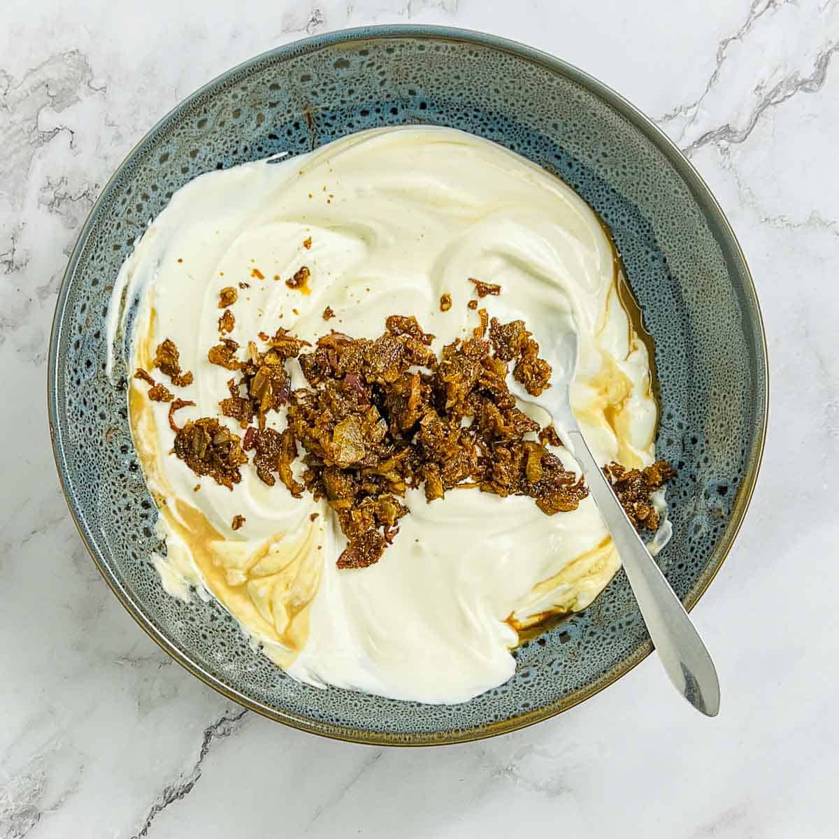 Onion mixture added to yogurt, liquid smoke, and lemon juice.