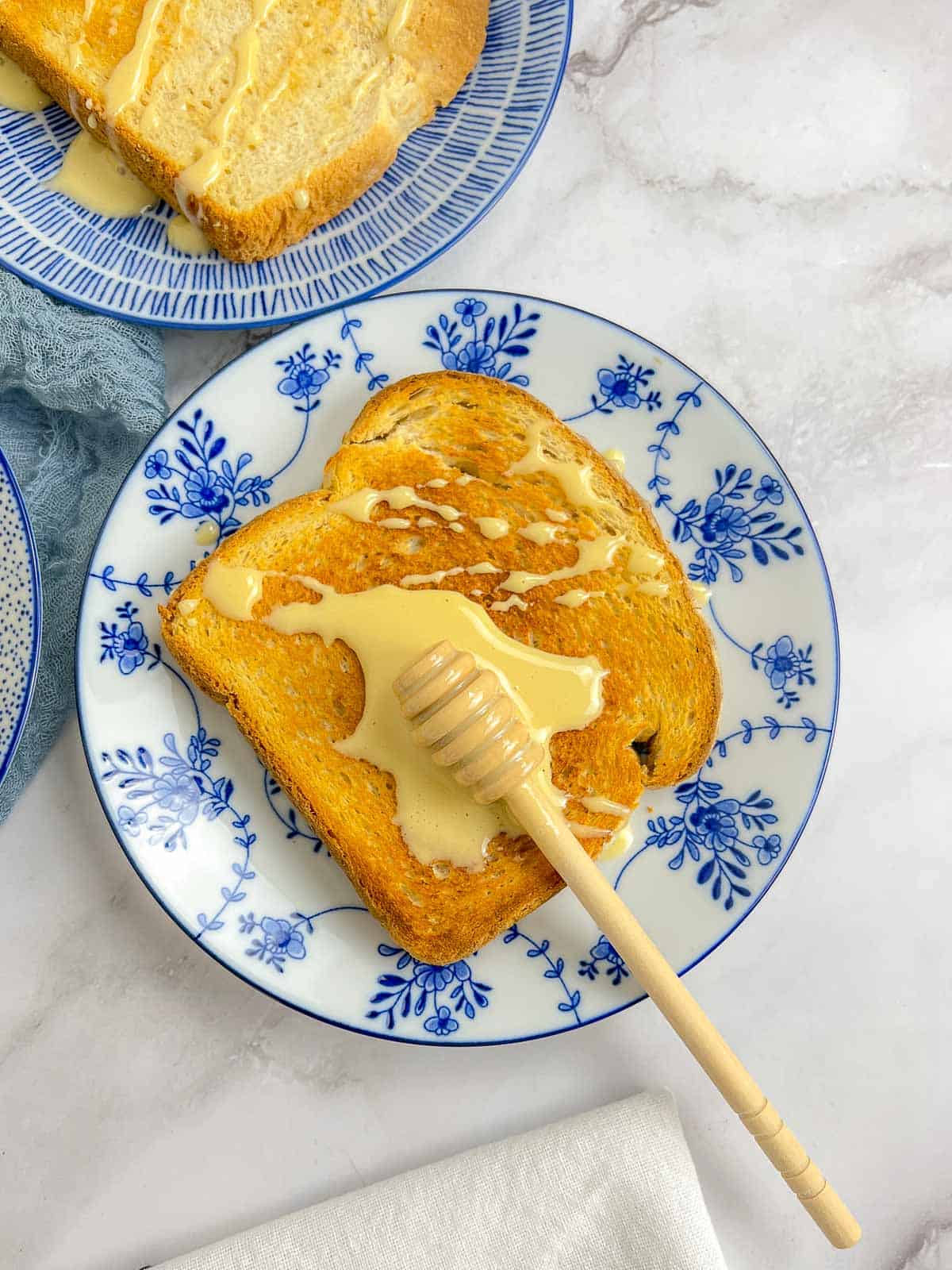 Whipped honey on a toasted bread with honey drizzle spoon on the top.