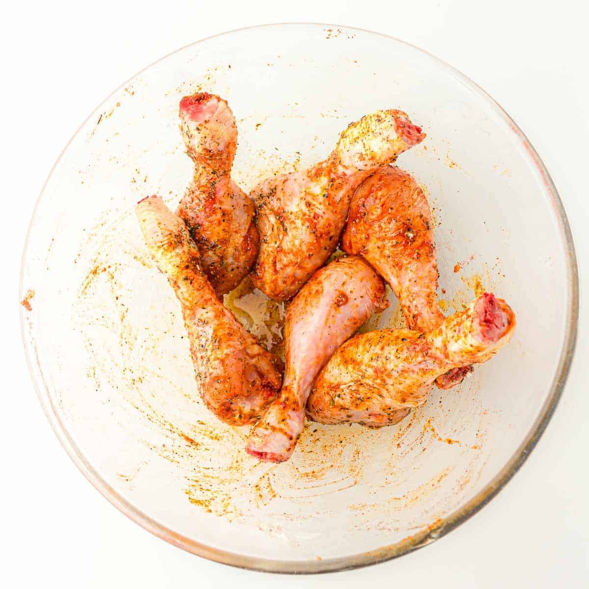 Chicken drumsticks rubbed with spices and seasonings.