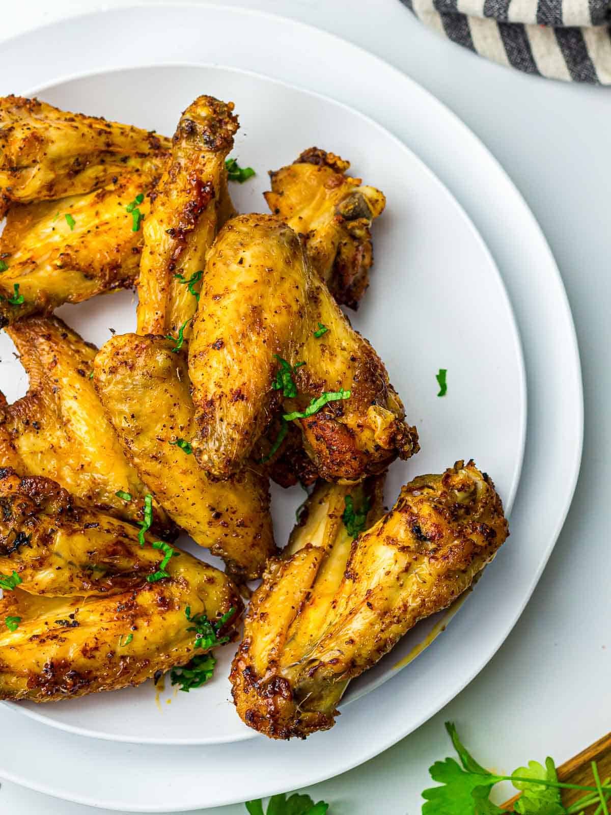 Air fryer chicken wings on a white plate.