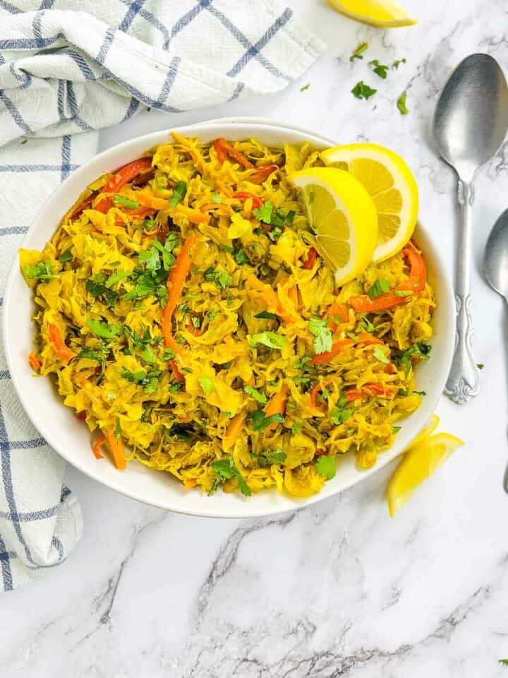 Curried cabbage stir fry in a white bowl.