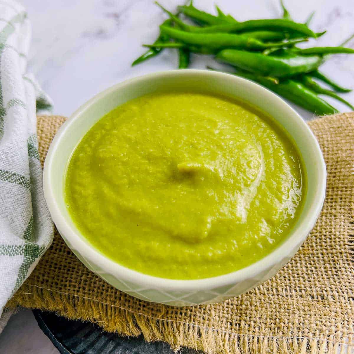 Green chili sauce in a white bowl.