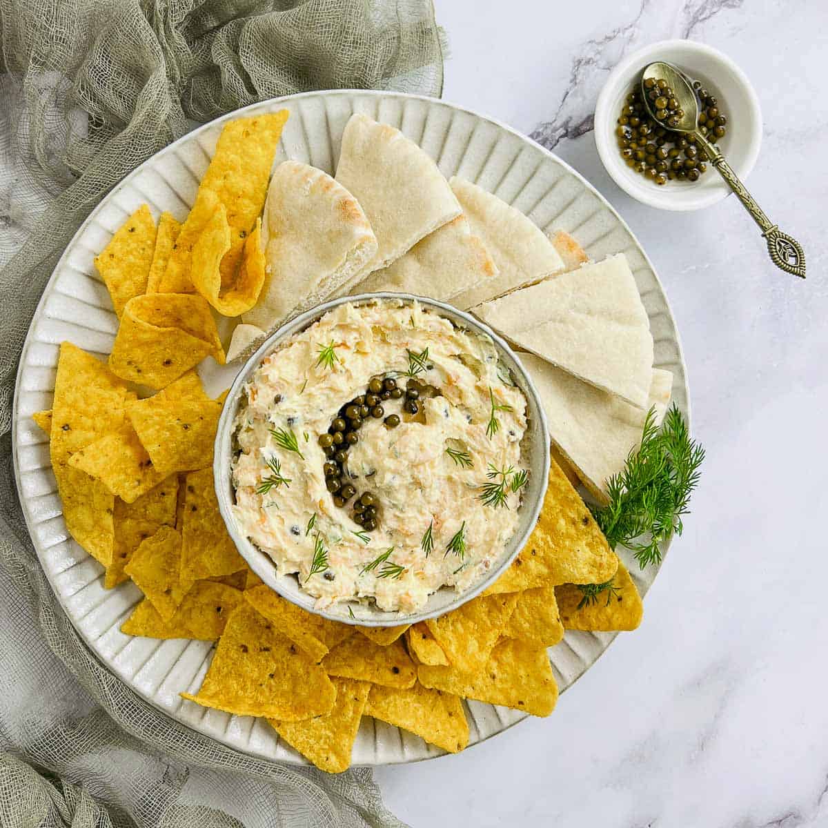 Salmon egg dip with green peppercorn in the background.