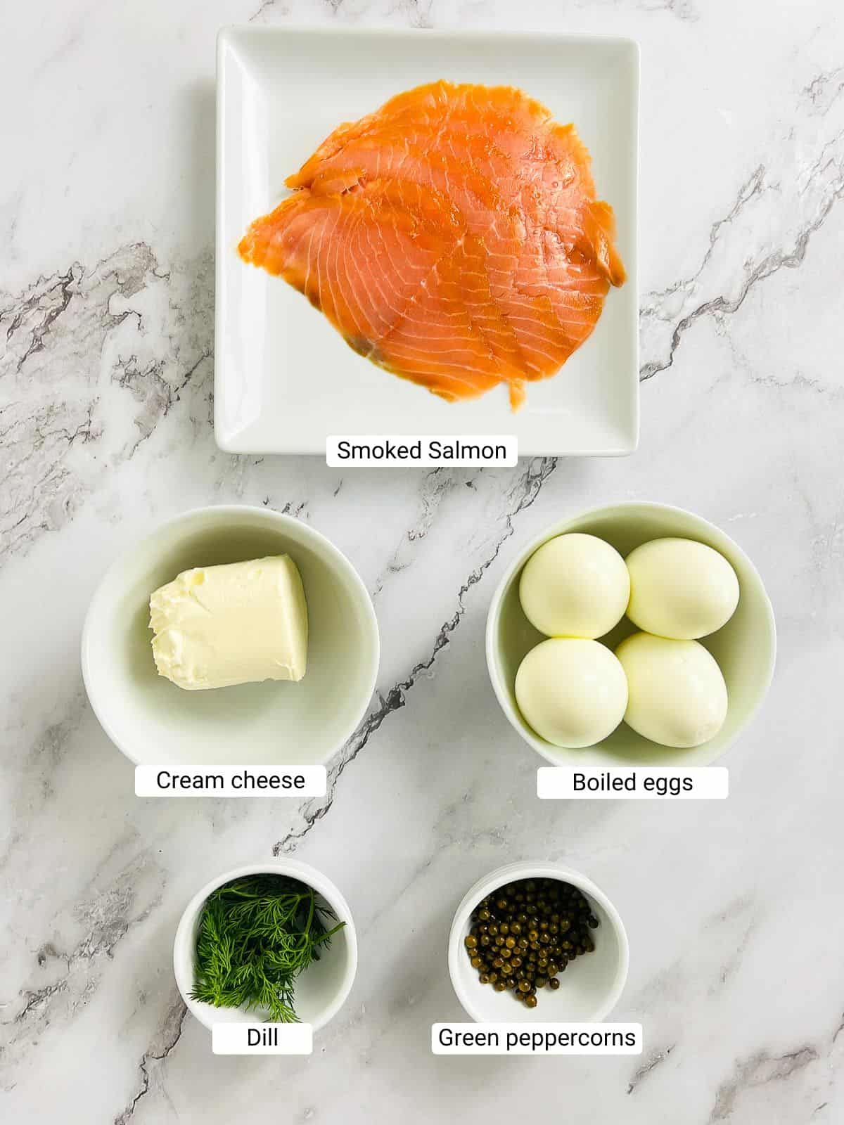 Ingredients to make salmon egg dip on a marble surface.