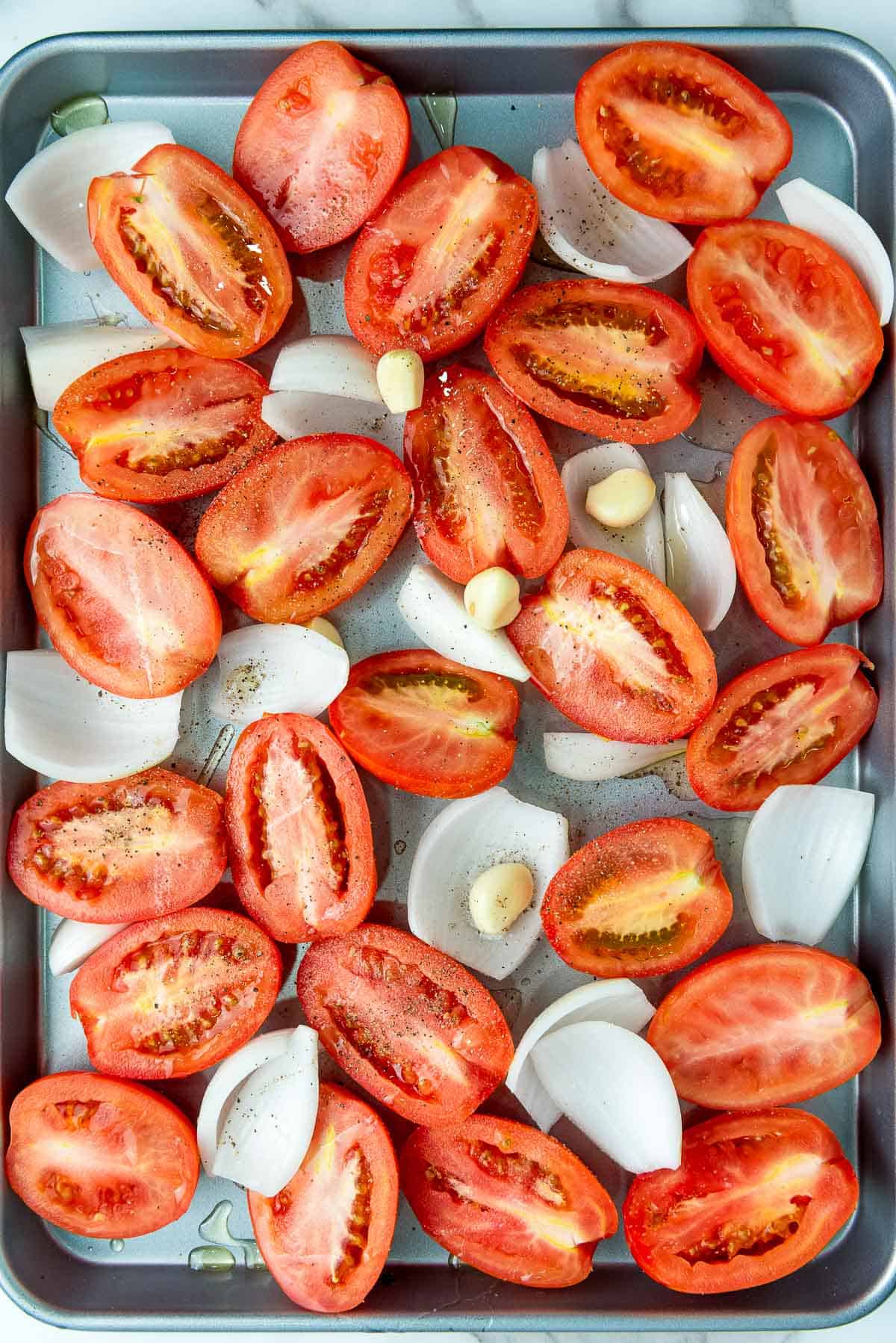 Seasoned veggies on a baking sheet.