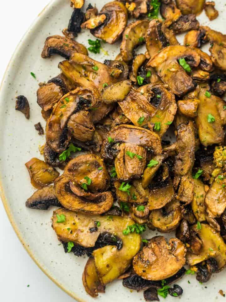 Garlic mushrooms in a white plate.