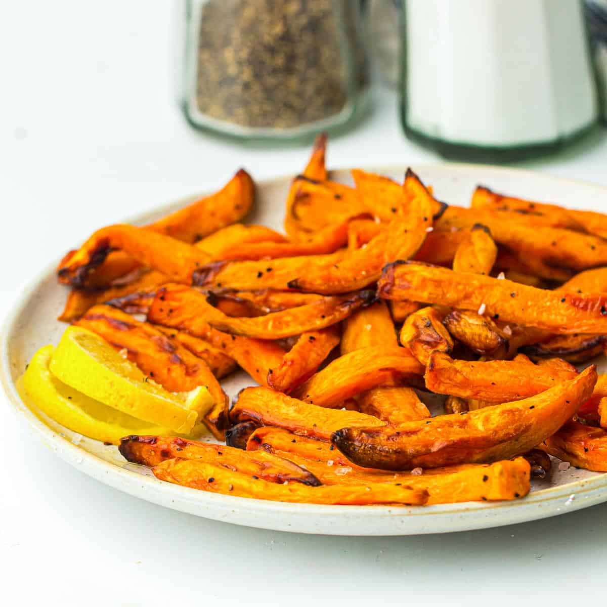 Sweet potato fries served on a round plate.