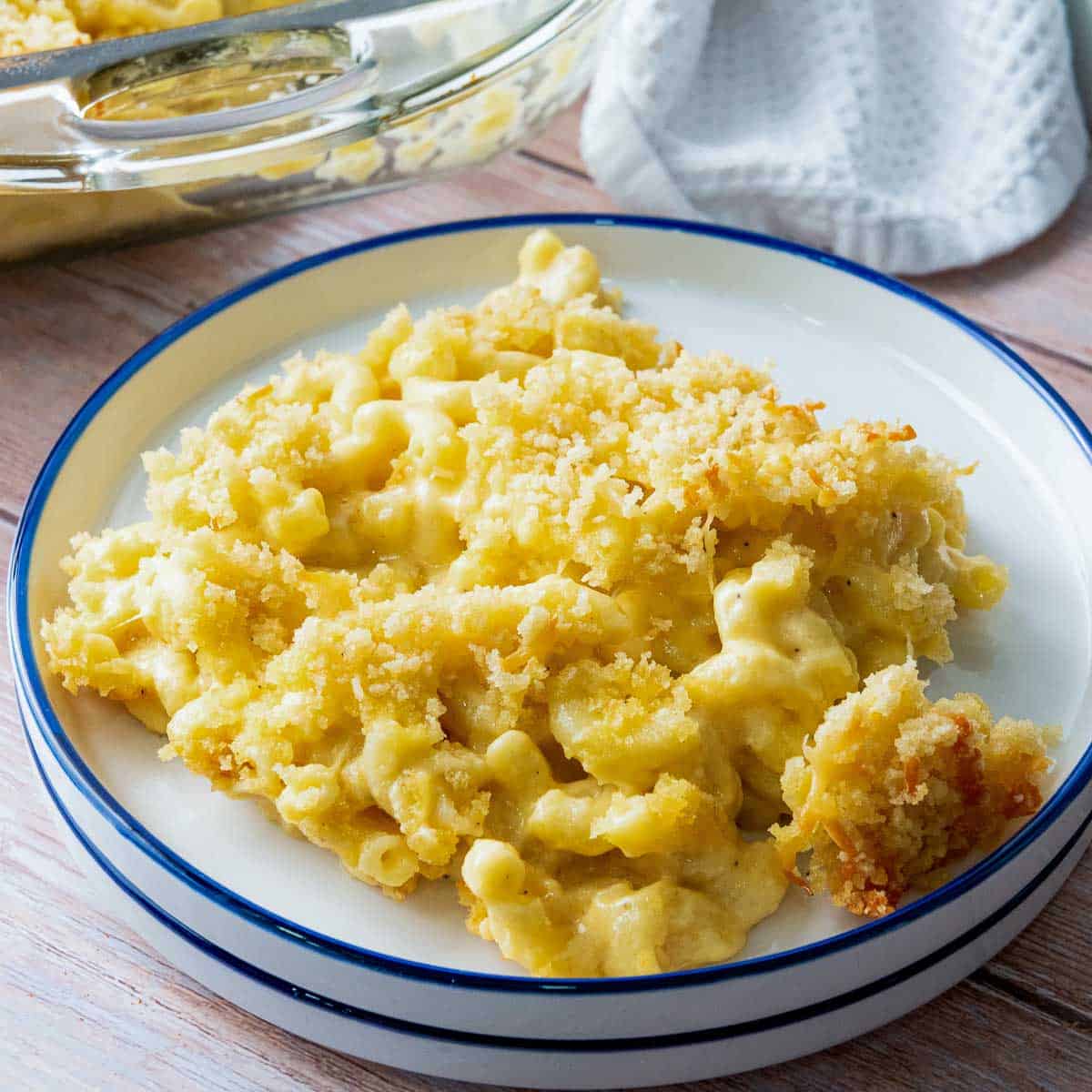 Baked mac and cheese on a stake of plates.