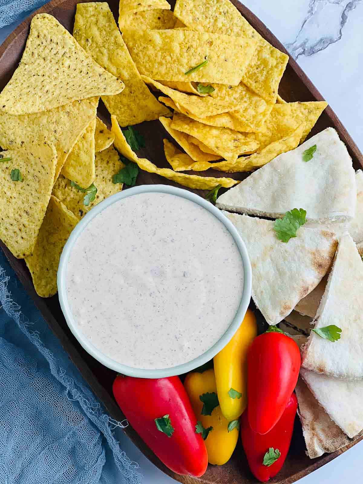 Snack platter with a bowl of black garlic dipping sauce.