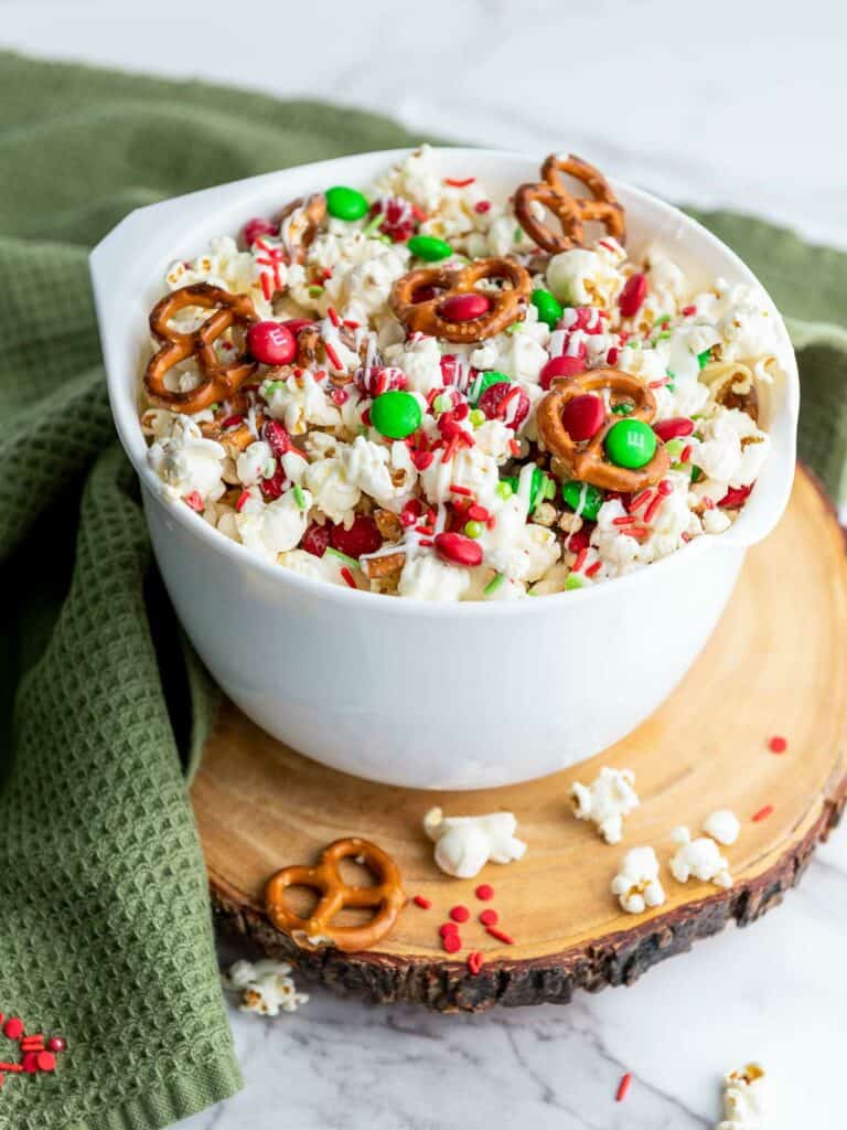 Christmas popcorn bowl placed on a wooden board.