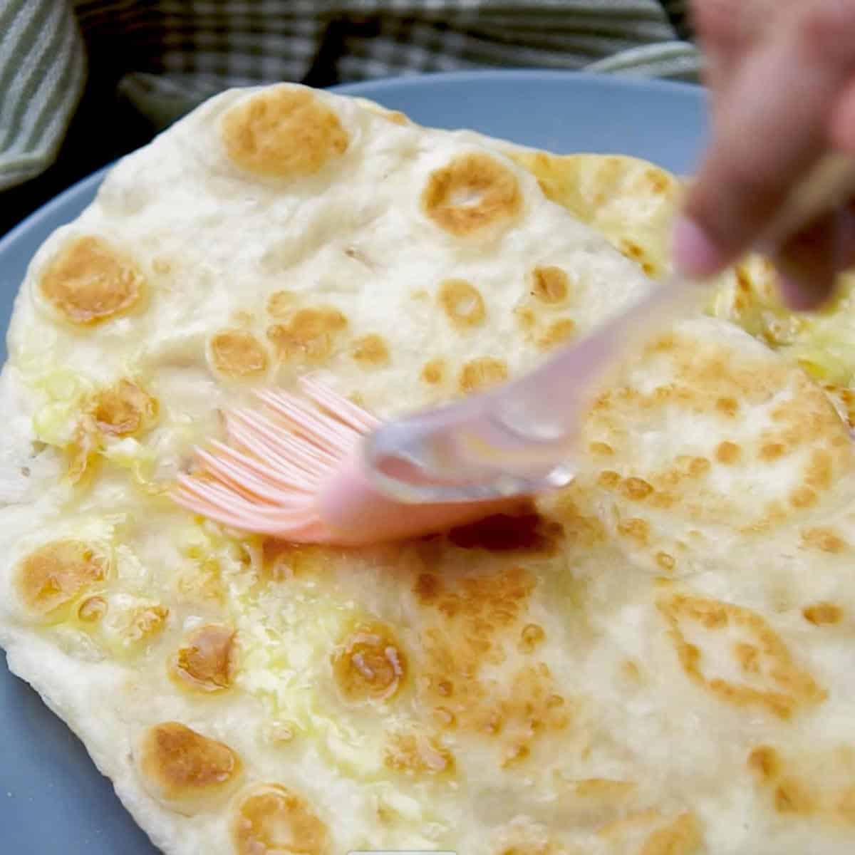 Naan brushed with garlic butter.