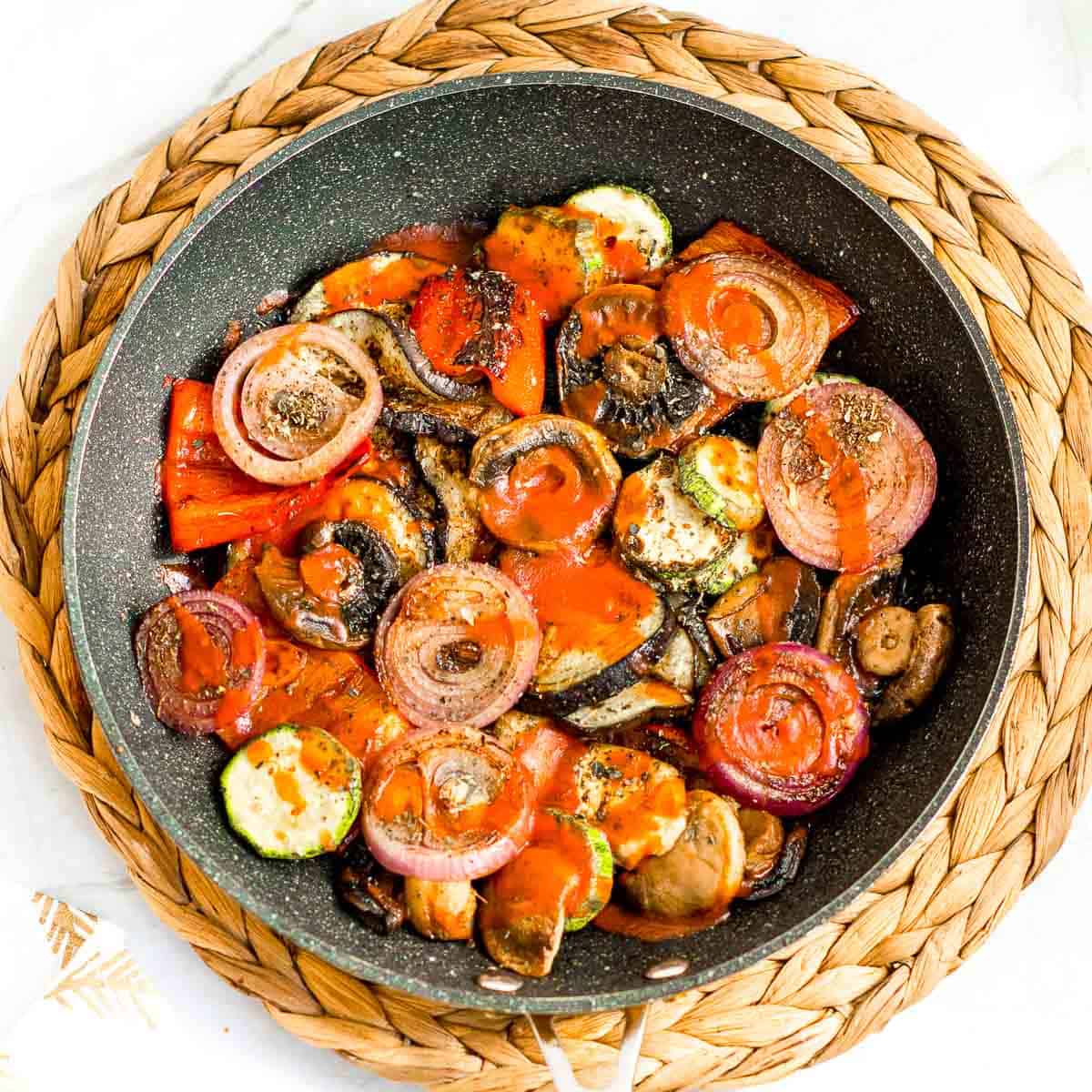 Sauted veggies in a skillet.