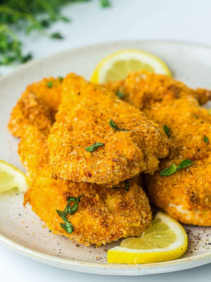 Air fryer chicken cutlet on a white plate.