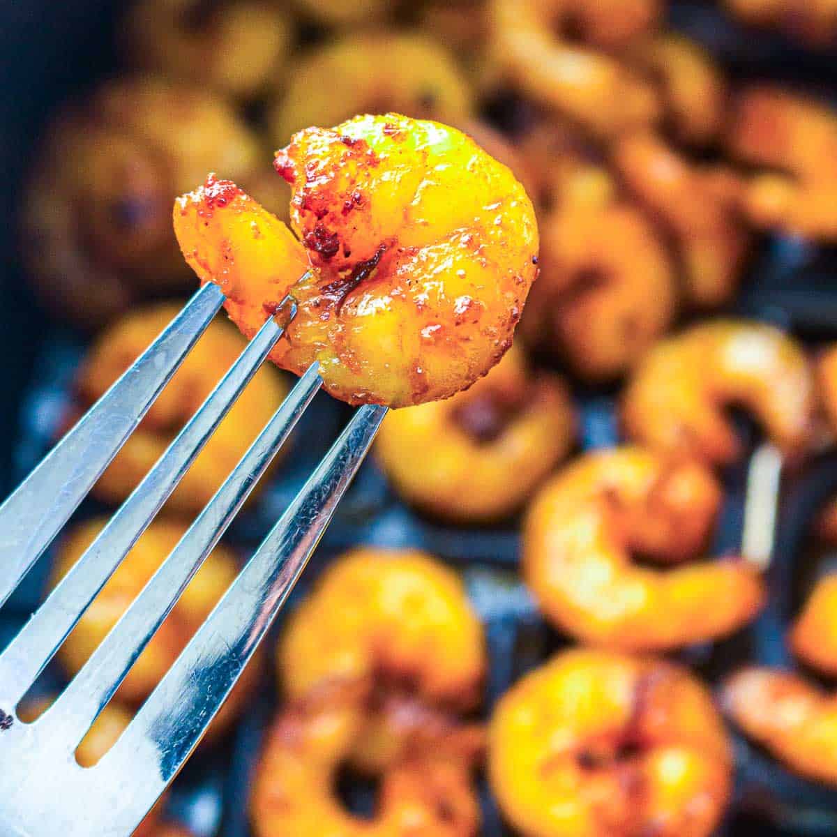 Roasted shrimp on a fork.