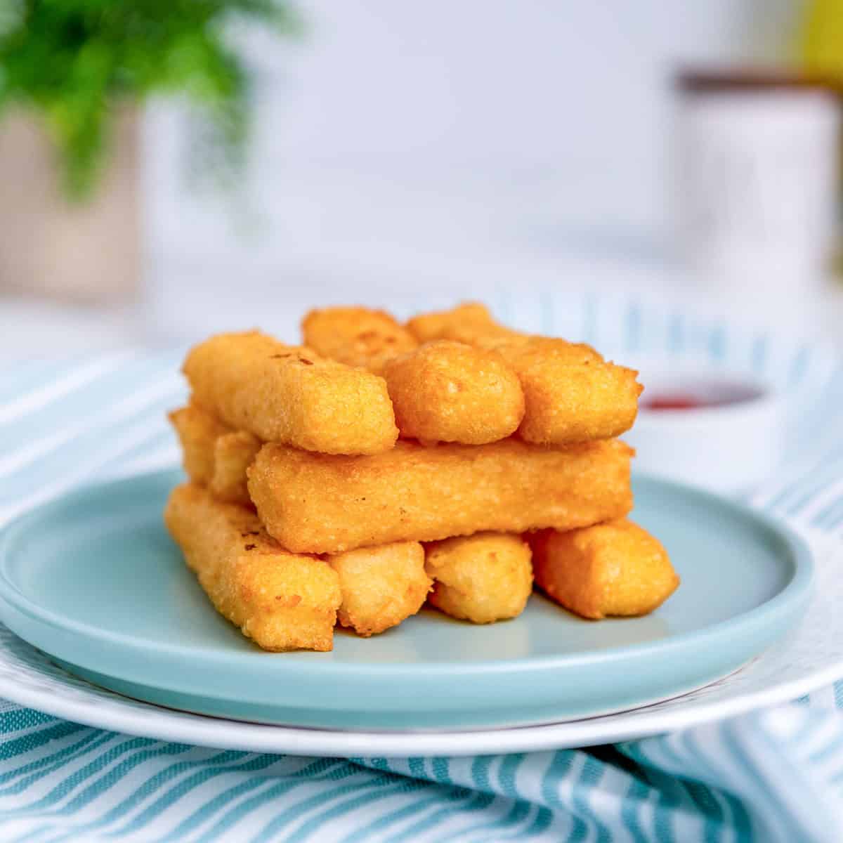 Potato cheese sticks on a blue plate.