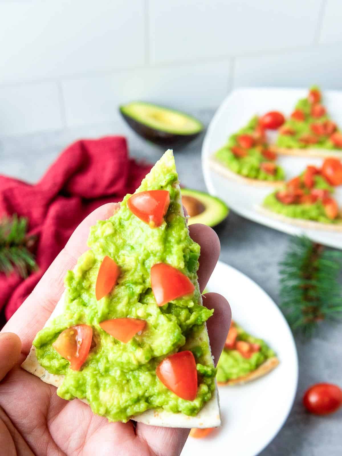 Holding a Christmas pita tree appetizer.