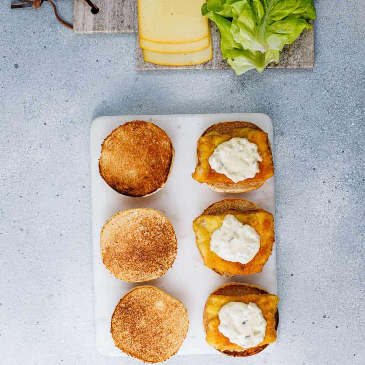 Fish filet and sauce over the burger buns.