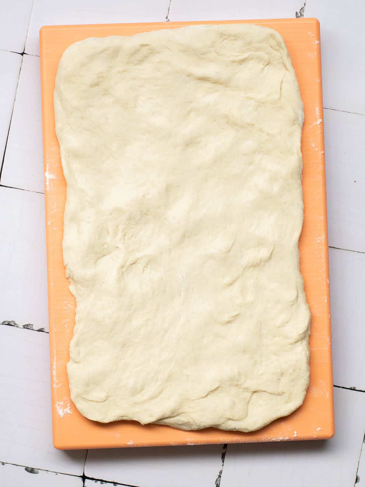 One part of dough spread into a rectangle.