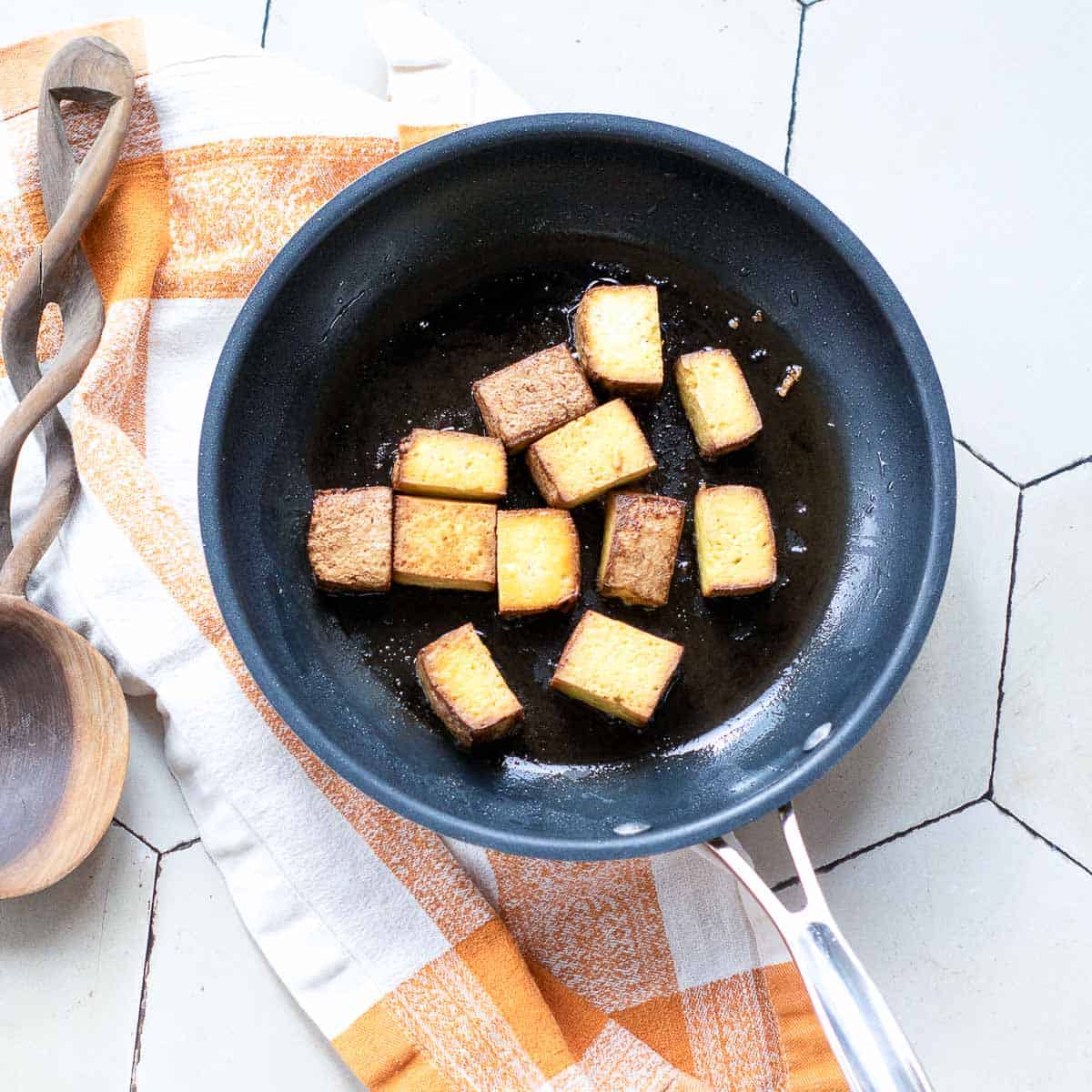 Sauted smoked tofu in a pan.