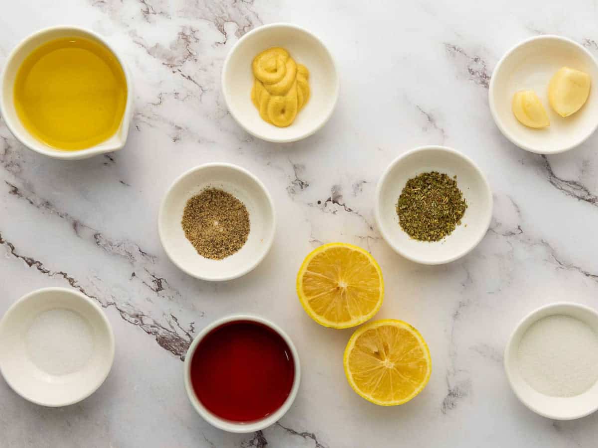 Dressing ingredients placed on a marble surface.