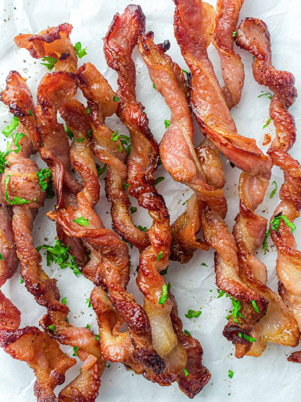 Twisted bacon garnished with parsley.