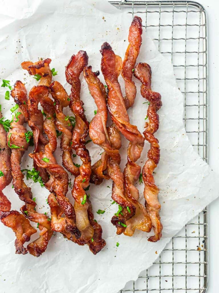 Twisted bacon on a wire rack.