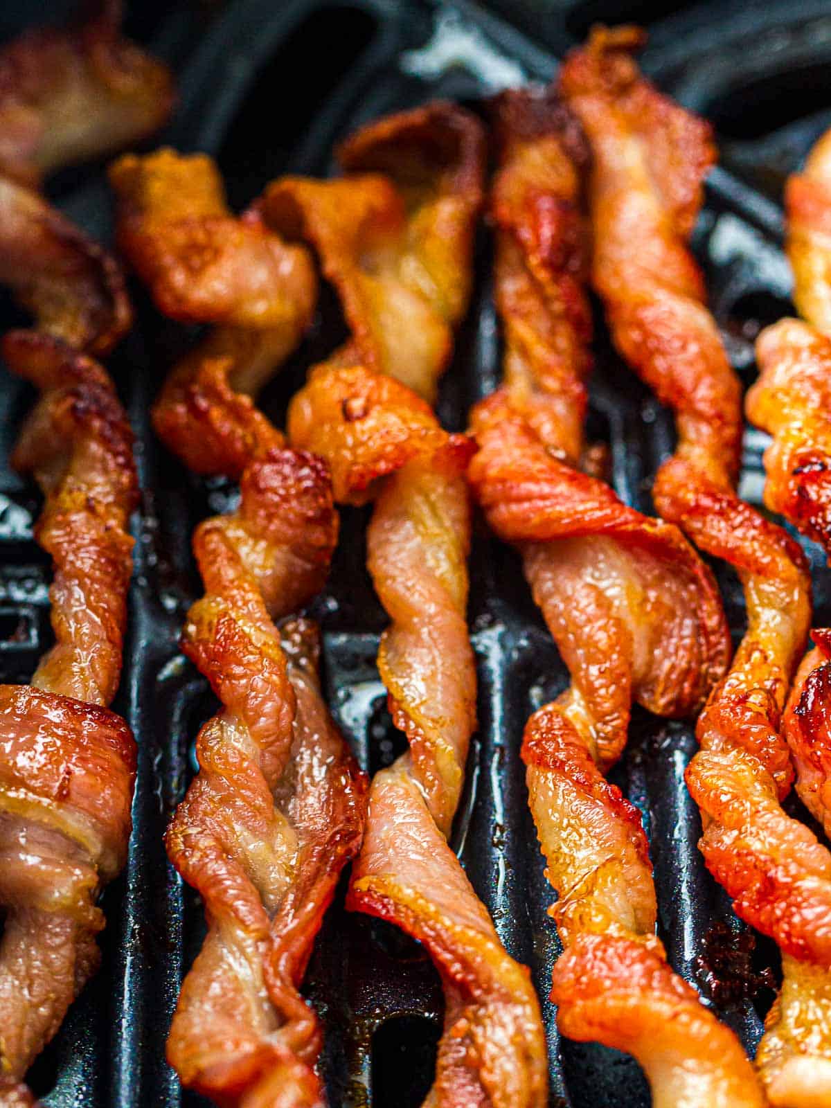 Close up of baked twisted bacon.