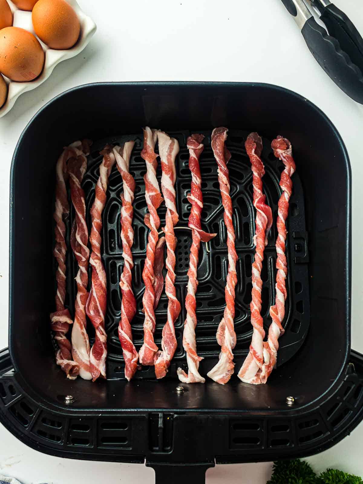 All the twisted bacon placed in the air fryer basket.