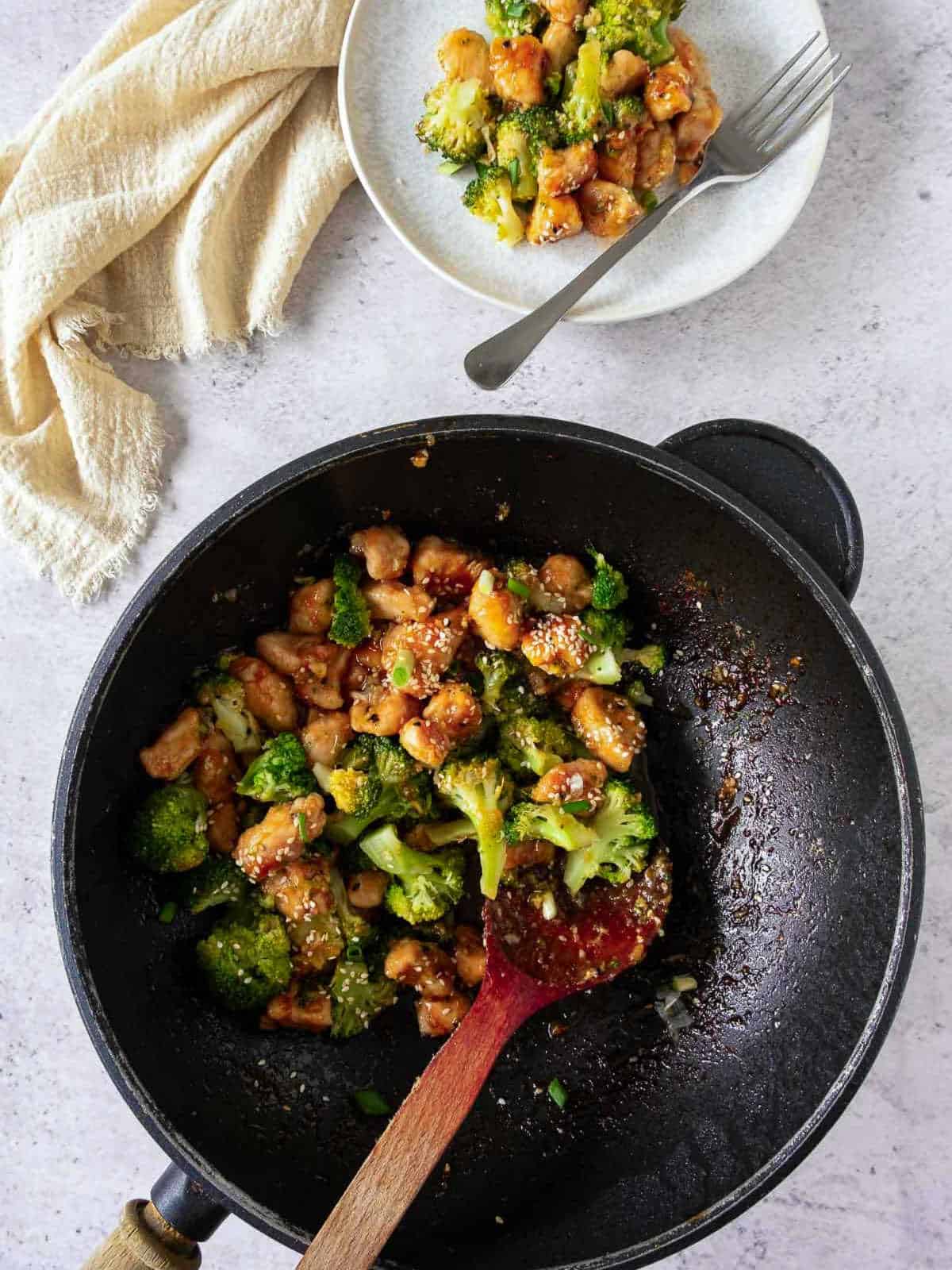 Honey garlic chicken served from wok to plate.